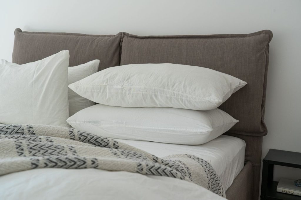 White pillows and neatly arranged bedding in a modern room