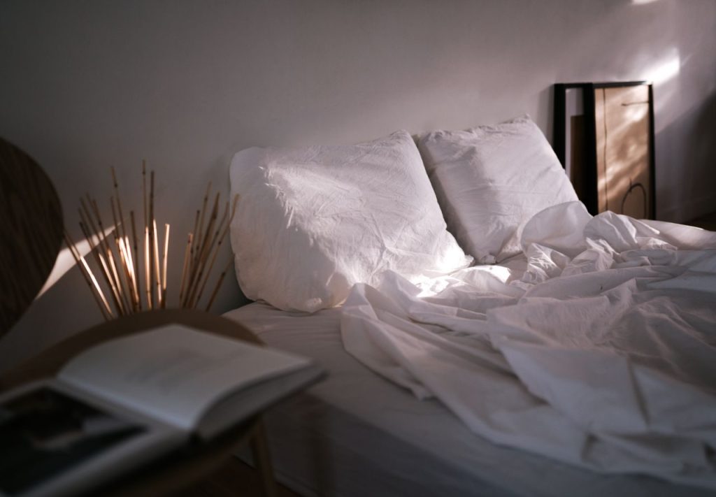 Bed linen and pillows illuminated by soft daylight