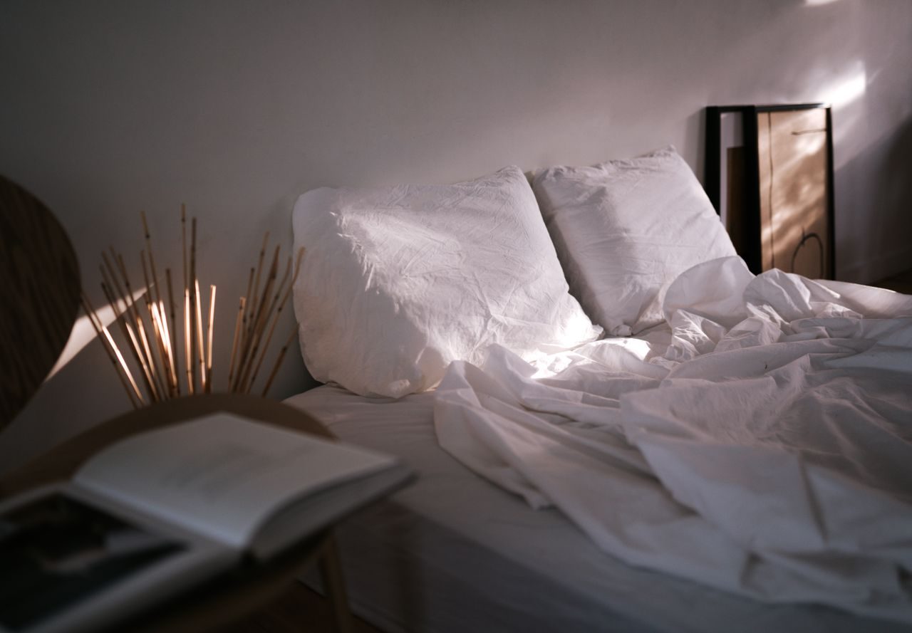 Bed linen and pillows illuminated by soft daylight